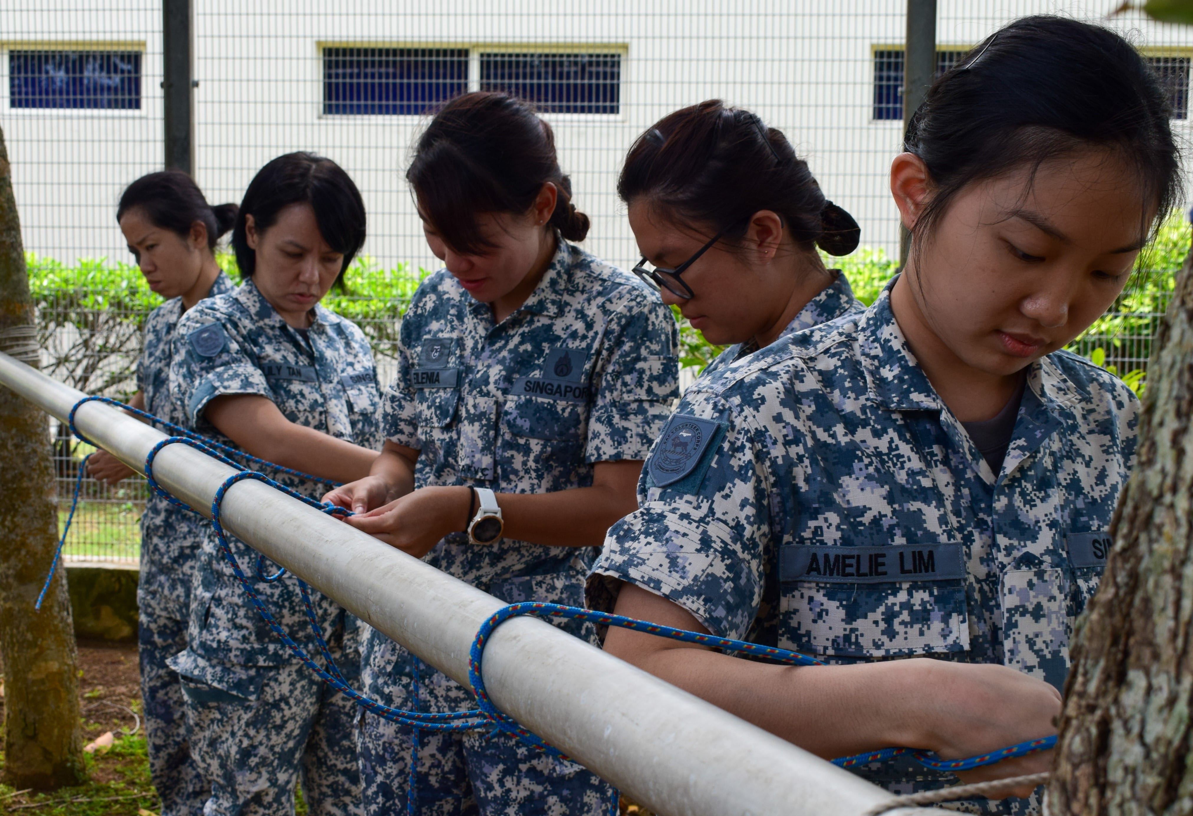 SAFVC Volunteers learning knot-tying techniques under instructor guidance.